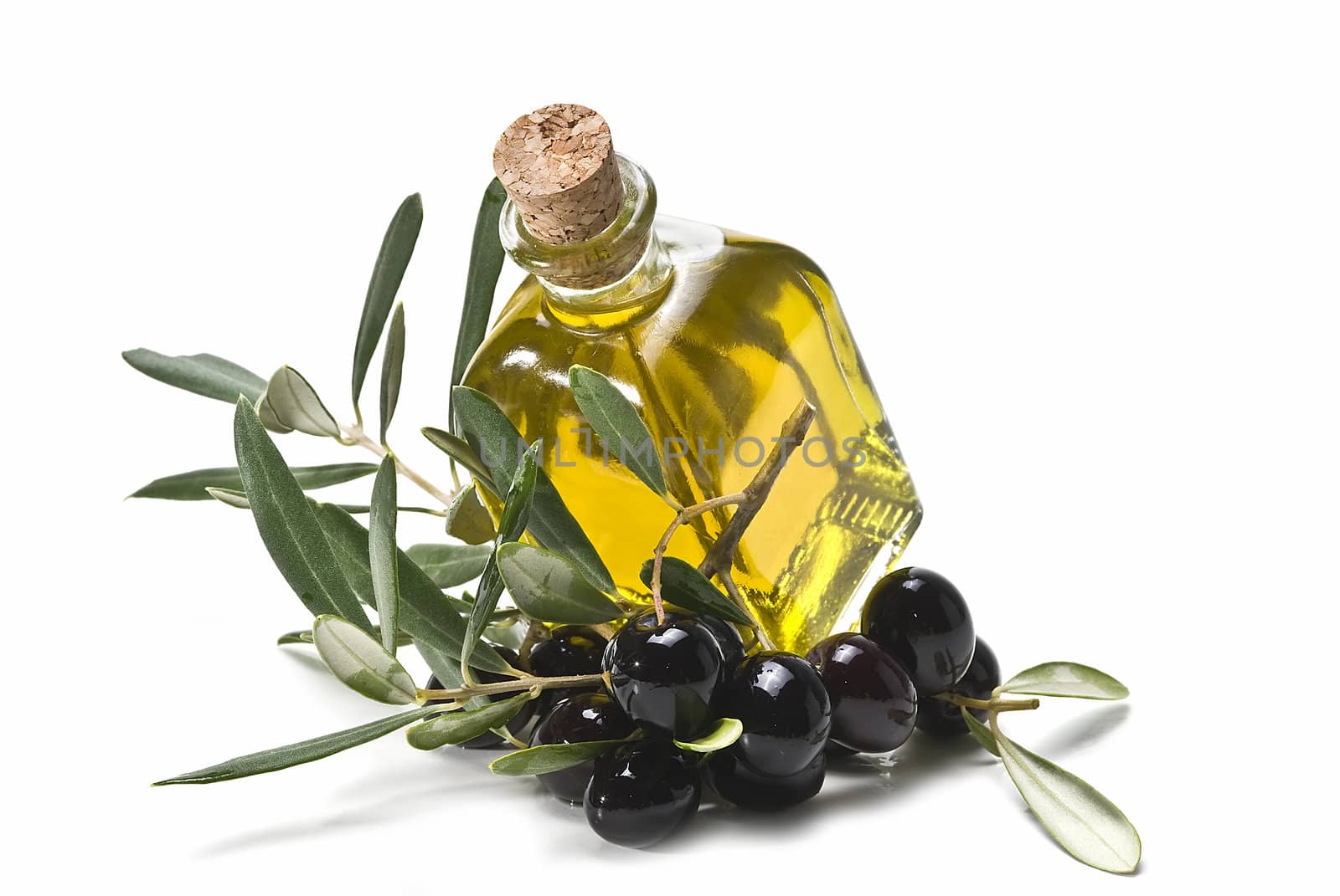 Some olives and olive oil isolated on a white background.
