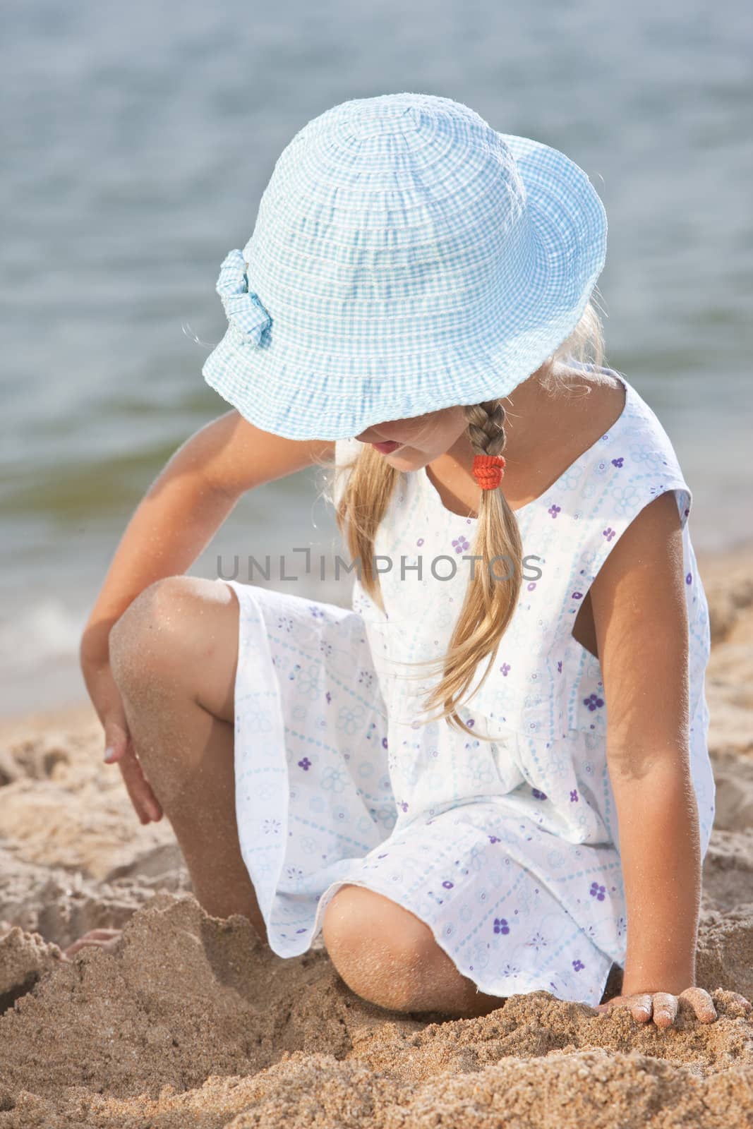 people series: little girl on sea beach are play the sandy game