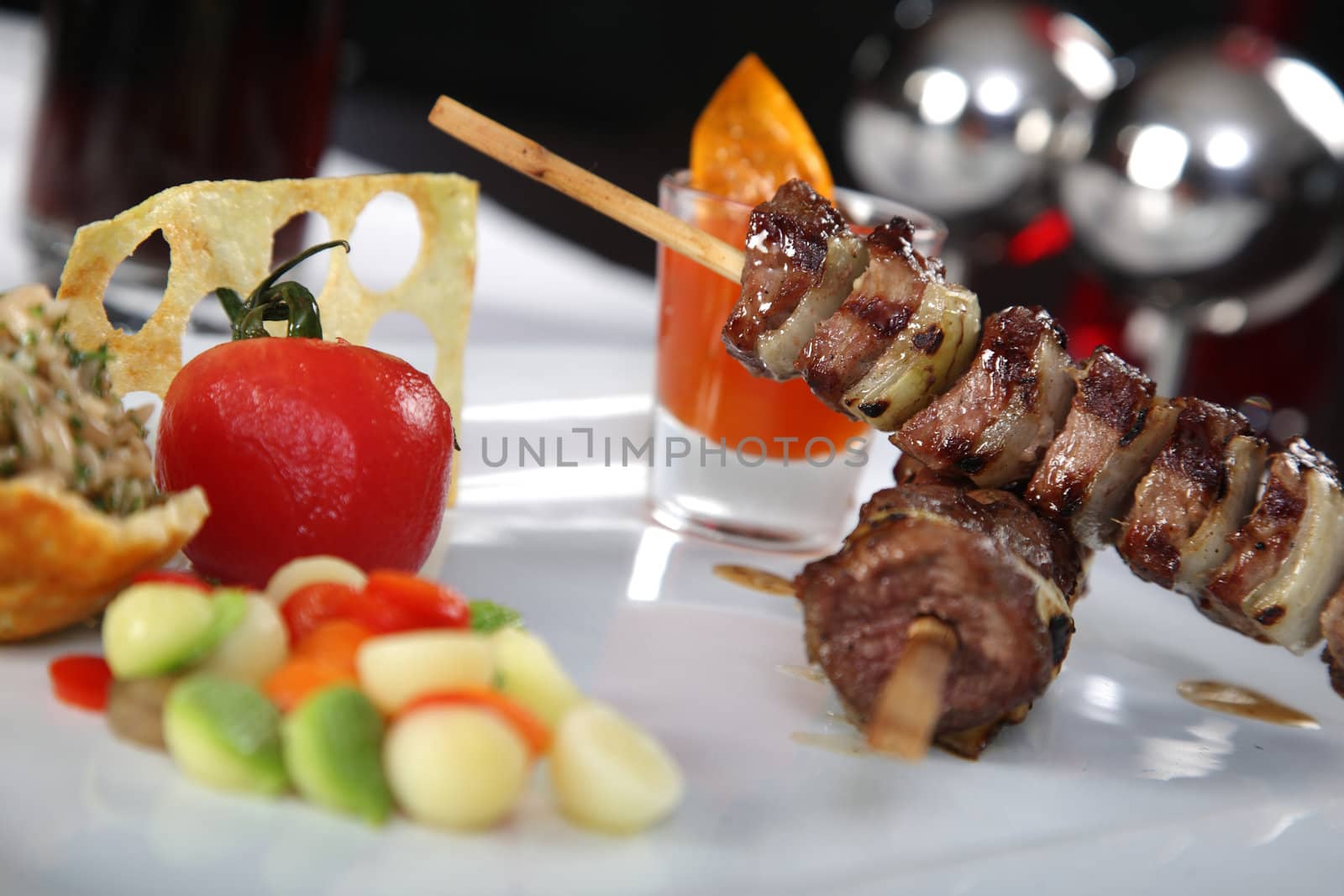 Delicious meat skewers with on a dish with vegetables 