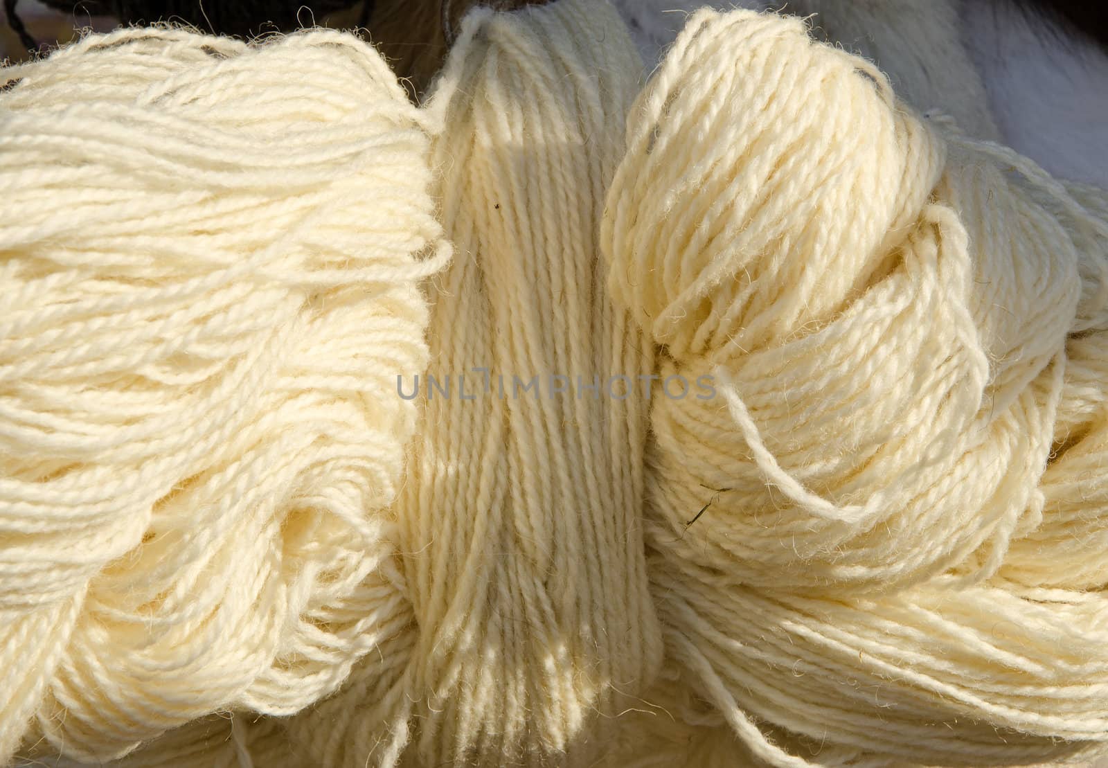 Roll of white woolen yarn. by sauletas