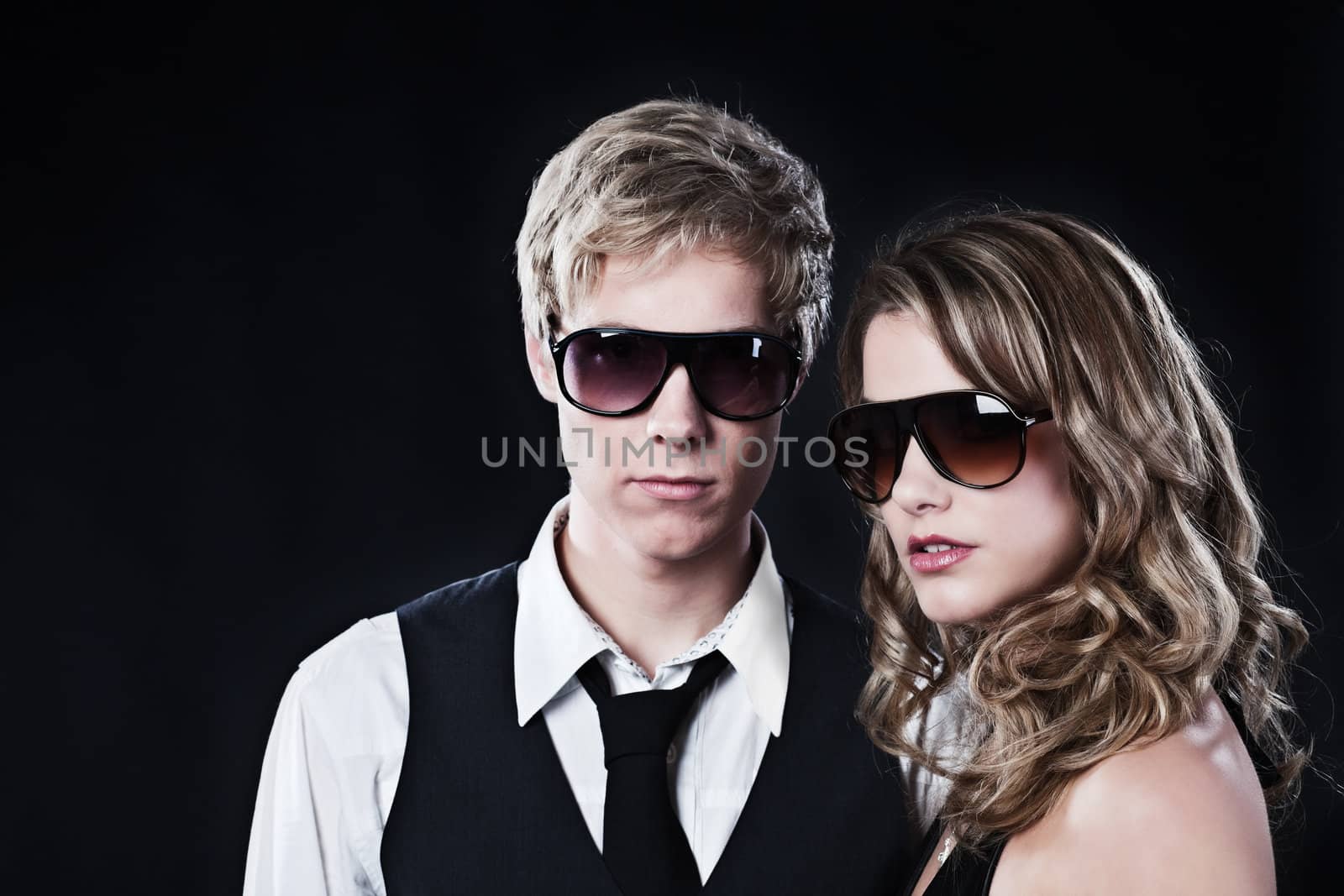 Young handsome man and young pretty woman in sunglasses