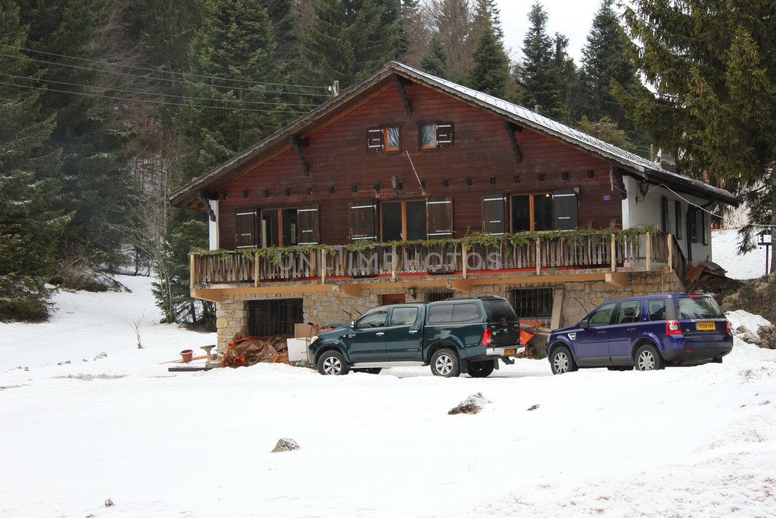 chalet and snow and cars