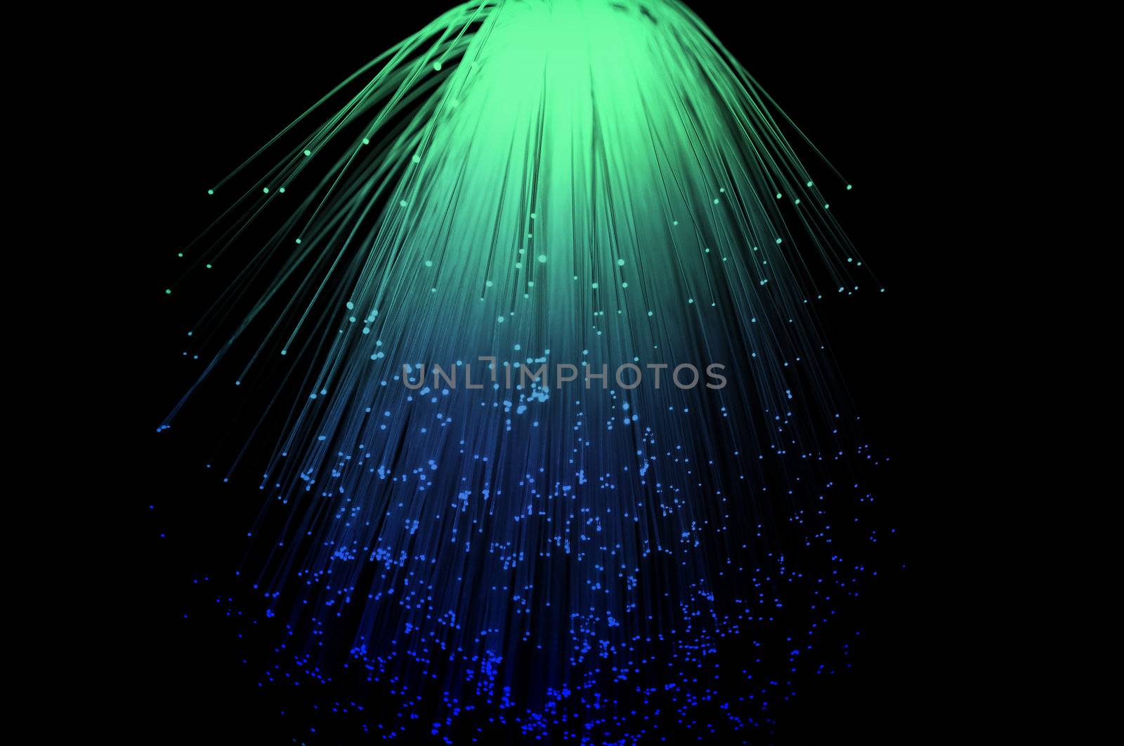 Blue and green coloured fibre optic light strands cascading down with a black background.