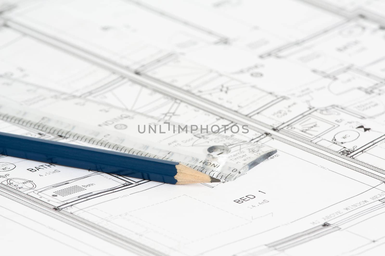 An architect's new building plan with ruler and blue pencil.