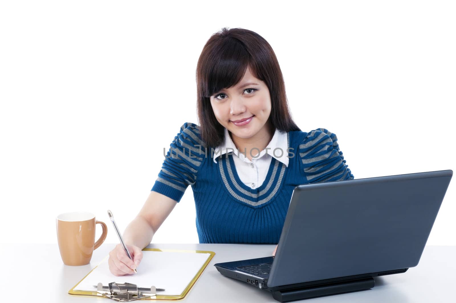 Portrait of a cute young female with laptop and writing on clipboard, isolated on white background.