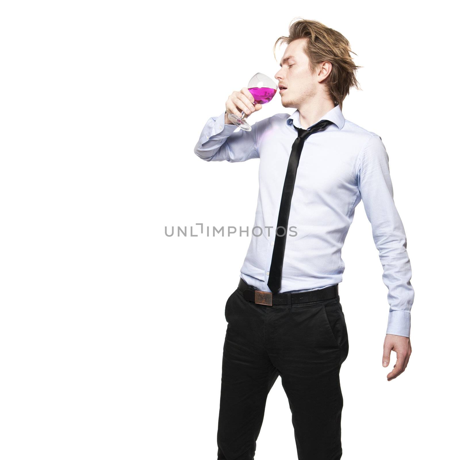 Young man holding a glass of pink wine. Studio photo of blonde man on white background.