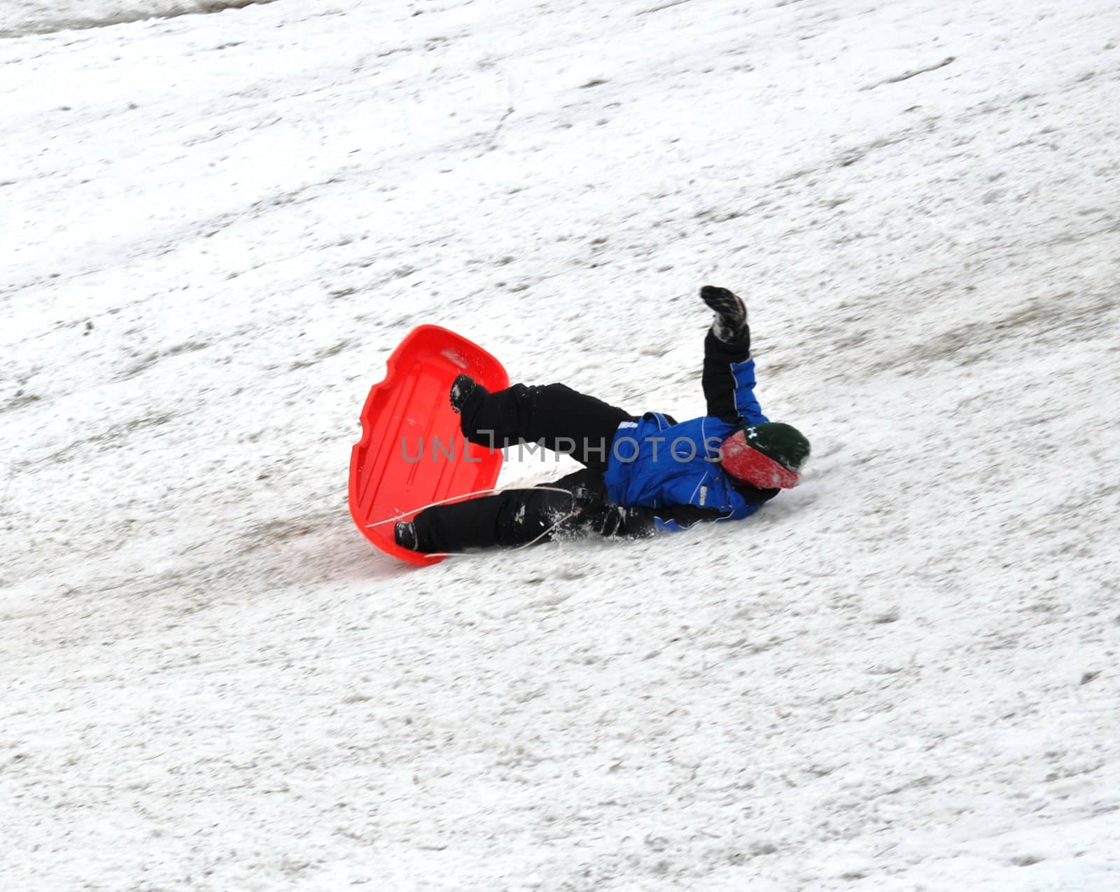 sledding and falling down the hill by RefocusPhoto
