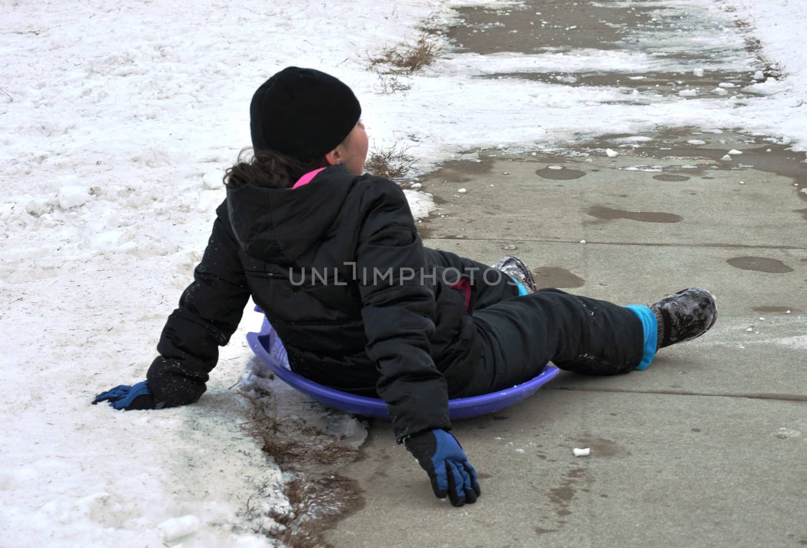 sledding at the bottom of the hill