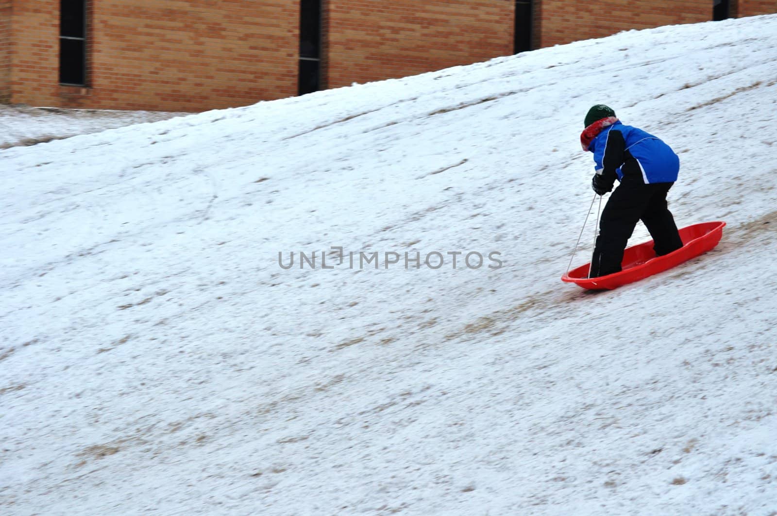 sledding near the sidewalk by RefocusPhoto