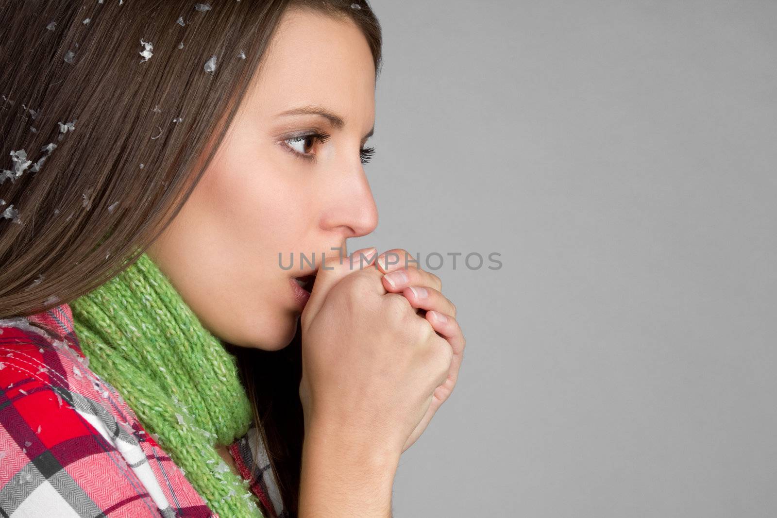 Cold young woman warming hands