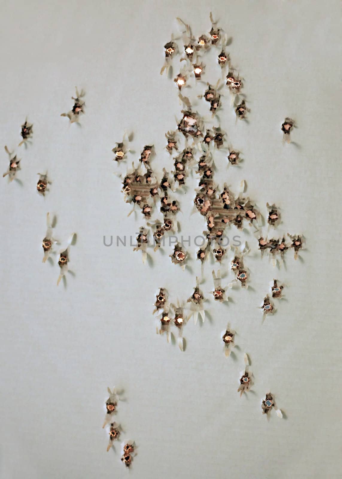 Old paper target with set of apertures from bullets