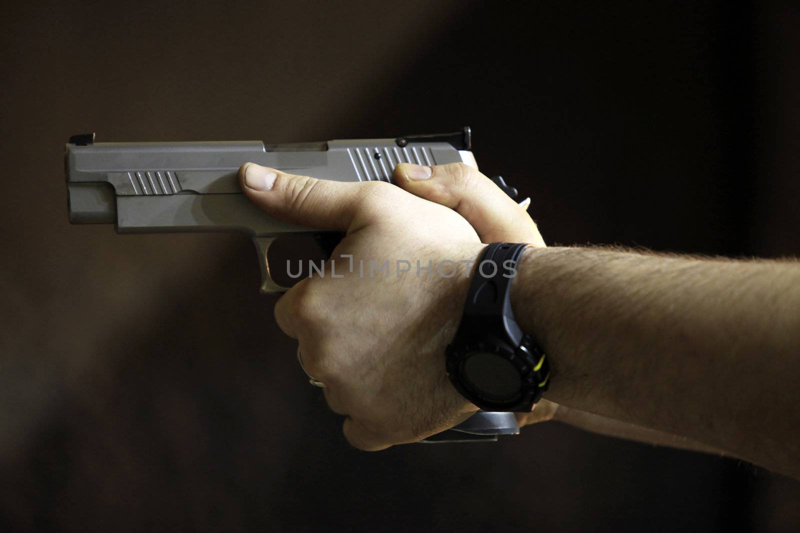 Man's hands with a pistol