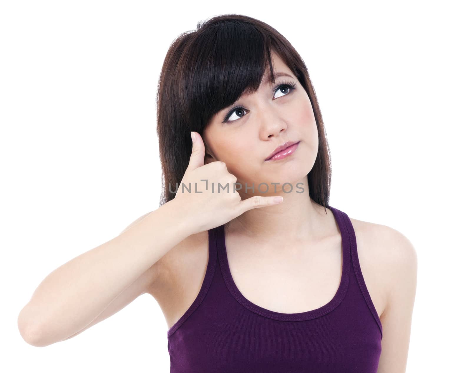 Portrait of an attractive young female making a call me gesture against white background