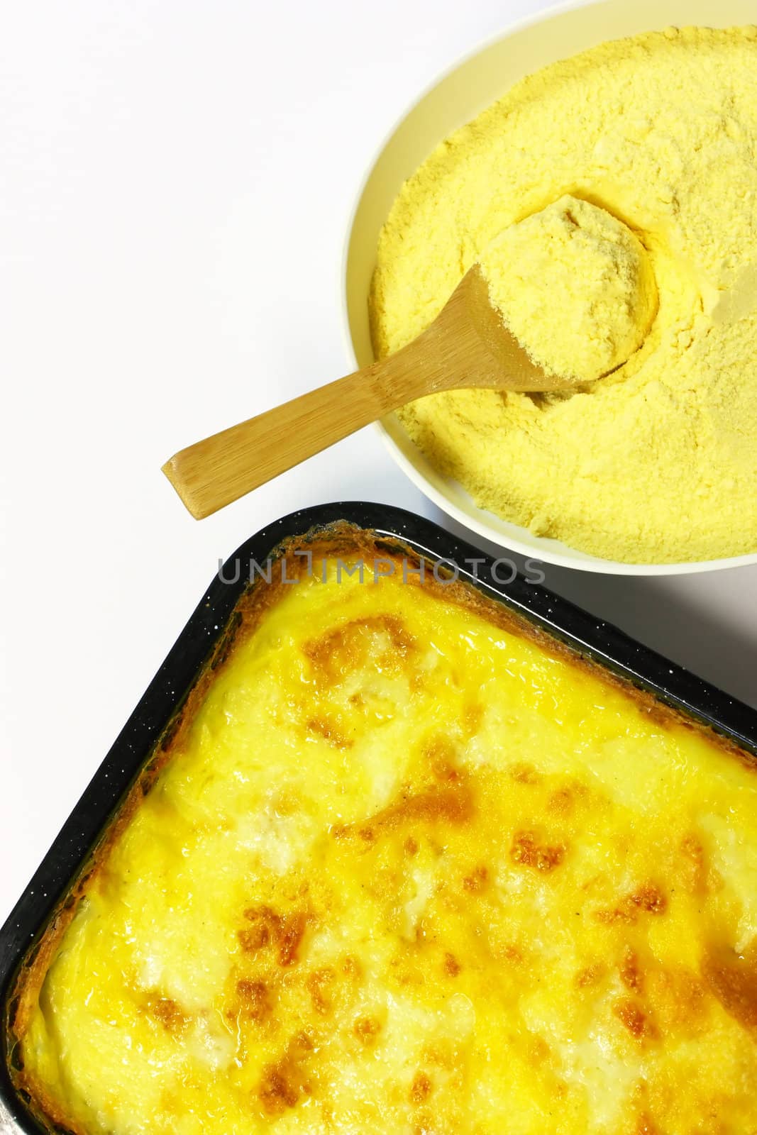Fresh cooked polenta with corn meal isolated on white