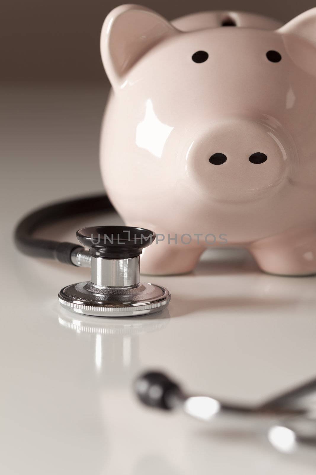 Piggy Bank and Stethoscope with Selective Focus on a Gradated Background.