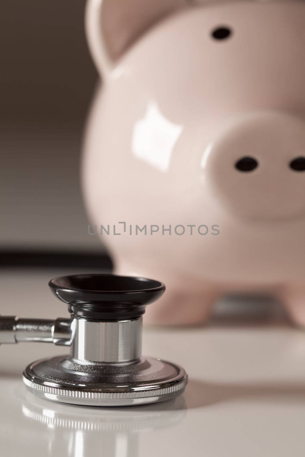 Piggy Bank and Stethoscope with Selective Focus on a Gradated Background.