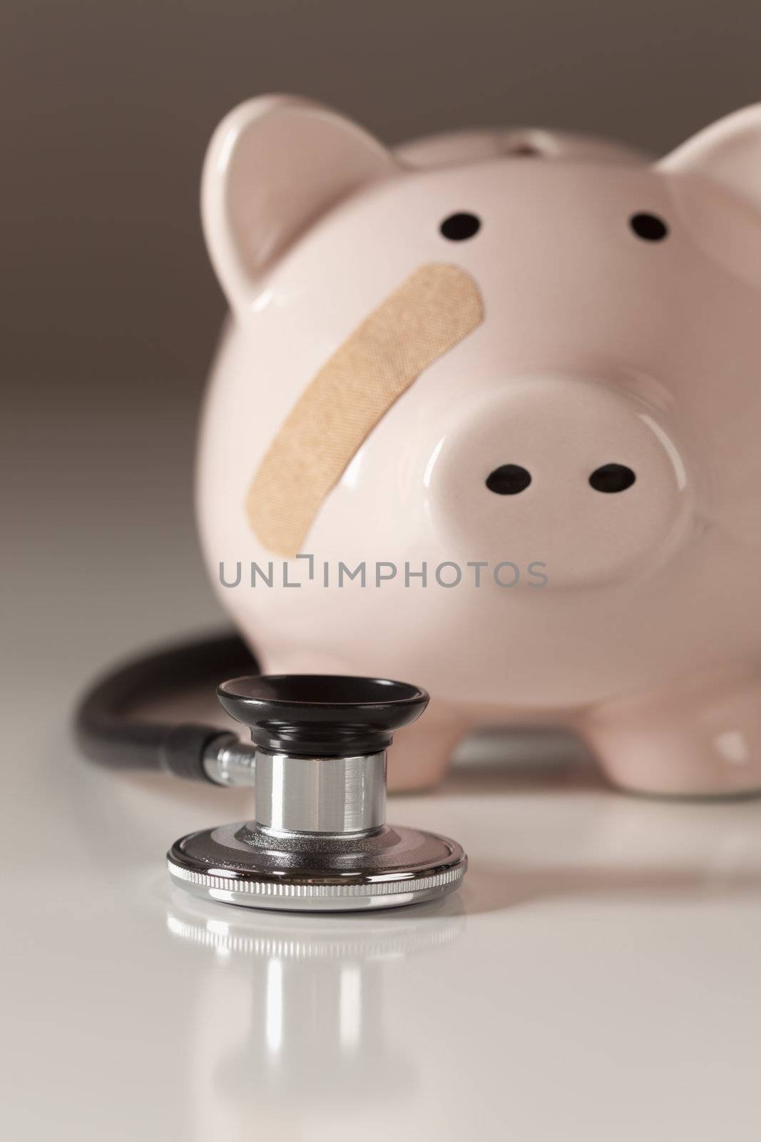 Piggy Bank and Stethoscope with Selective Focus by Feverpitched