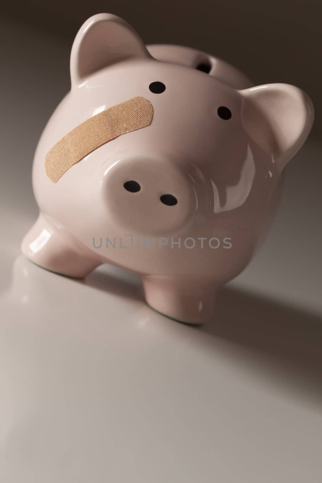 Piggy Bank with Bandage on Face on Gradated Background.