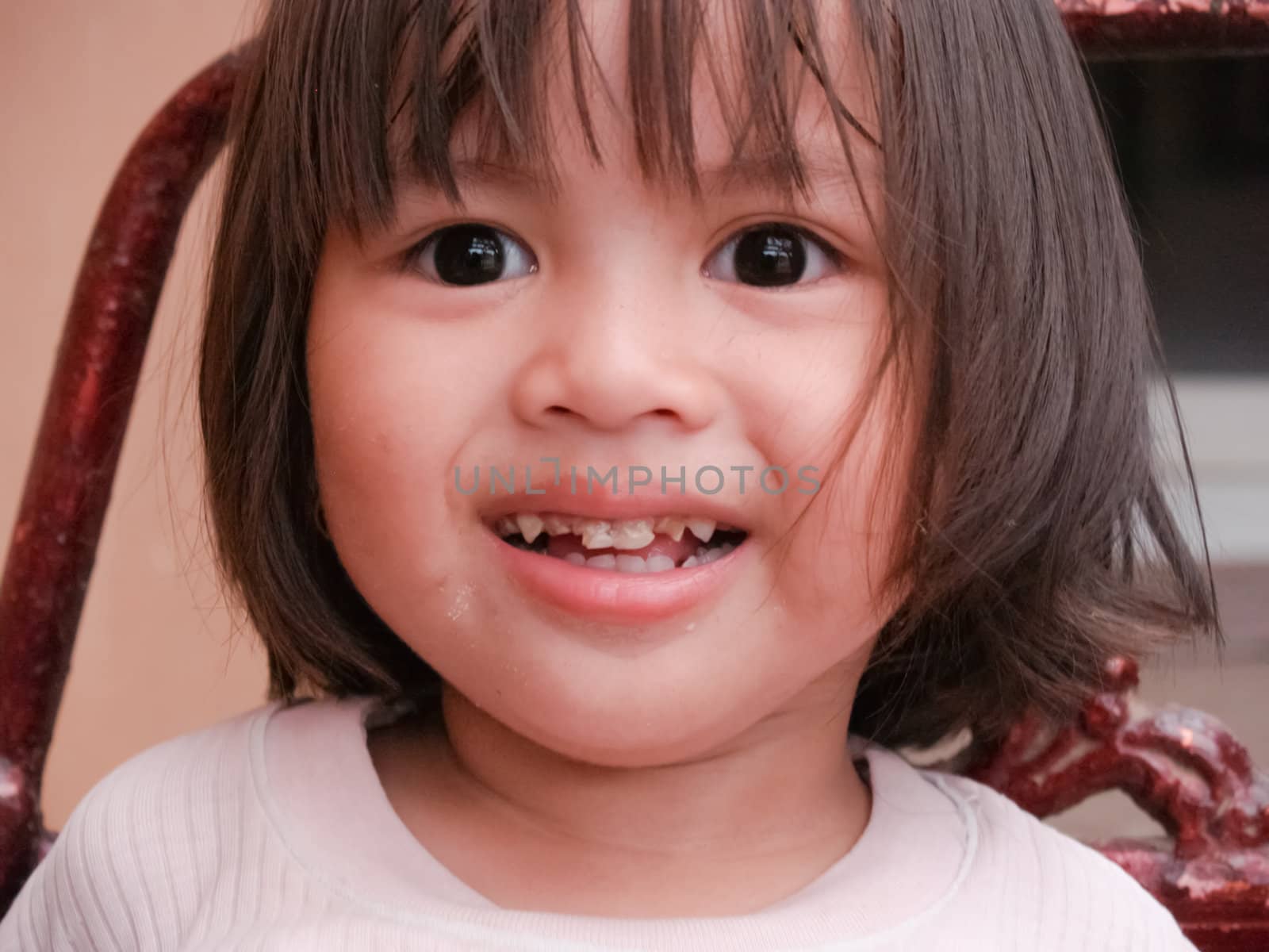 a smiling child looks up to see his teeth are missing.