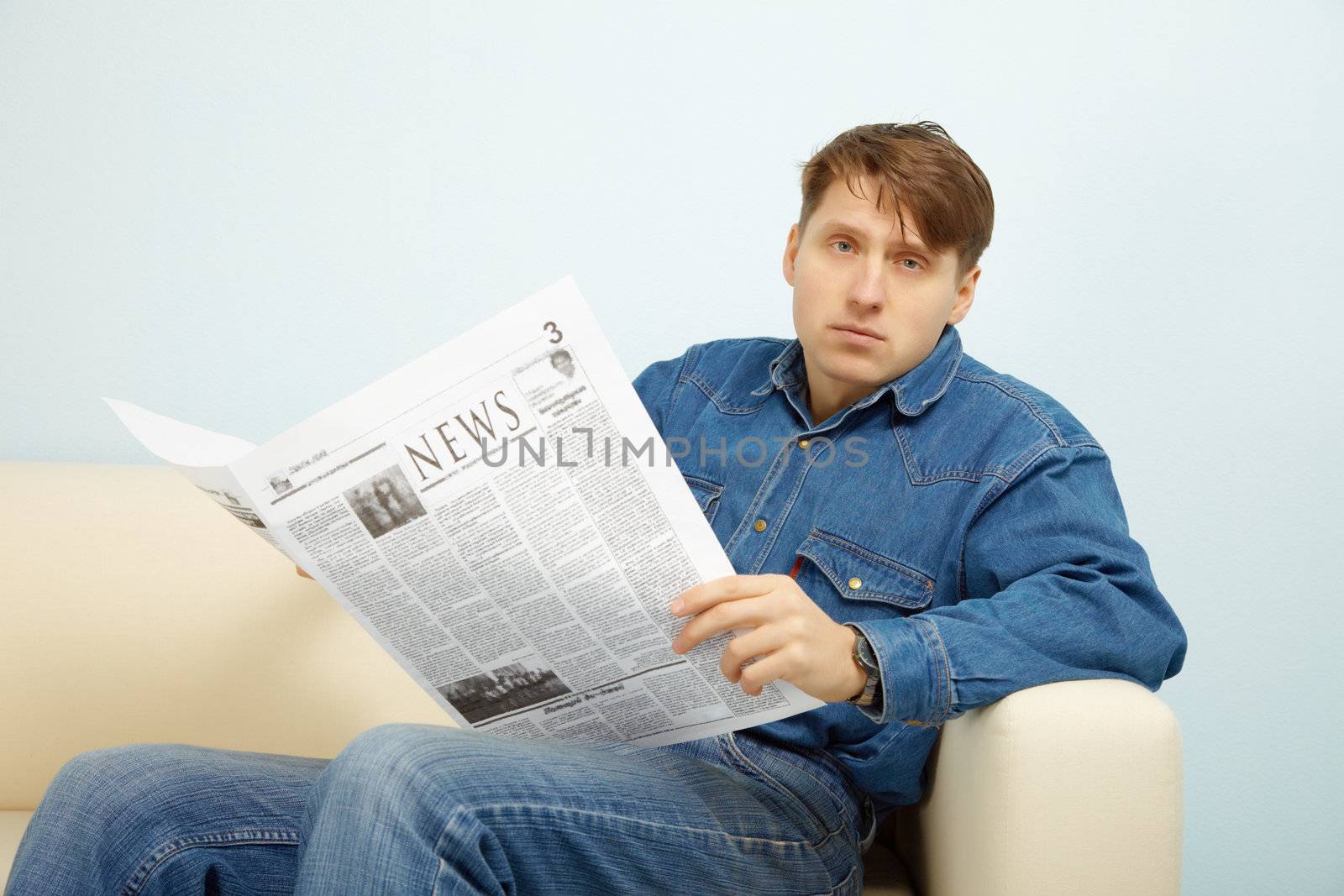 The young man disappointed with news from the newspaper