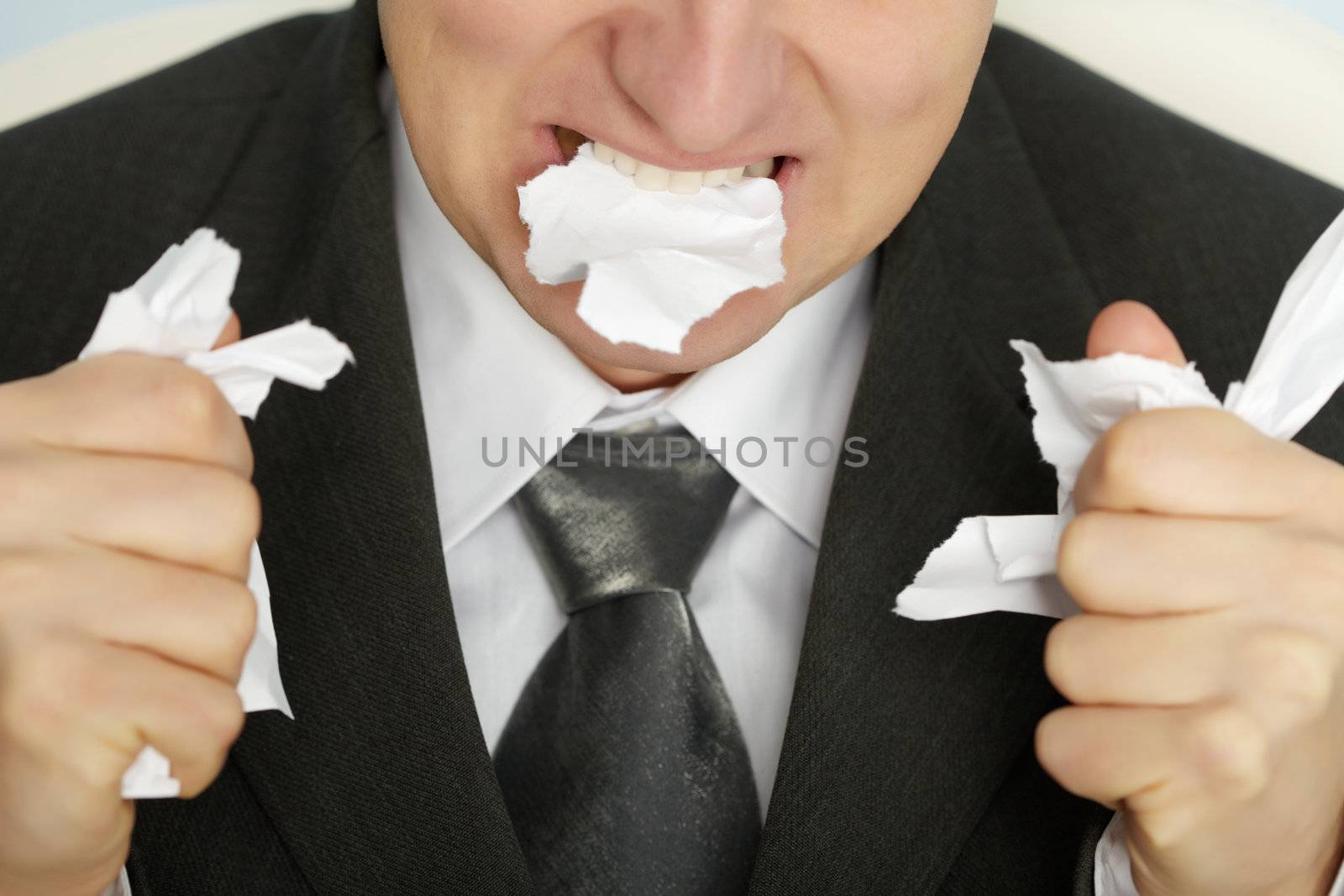 Businessman furiously tearing paper by pzaxe