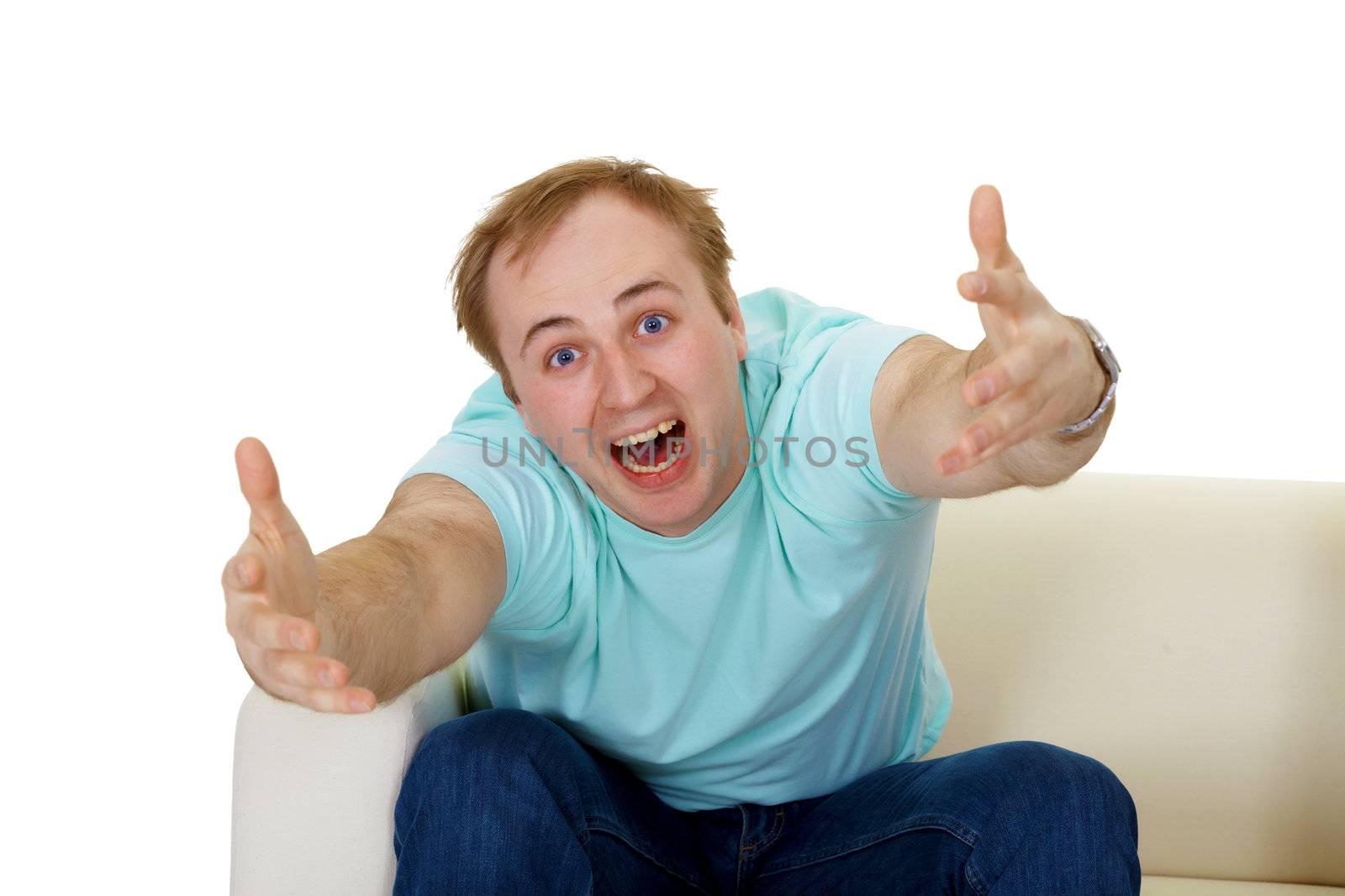 emotional man shouting, gesticulating, sitting on the couch. isolated on white background
