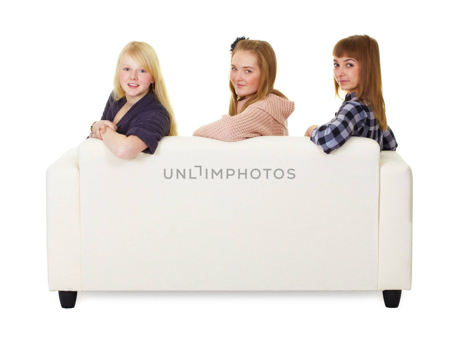 Three girls teens sitting on the couch on white background
