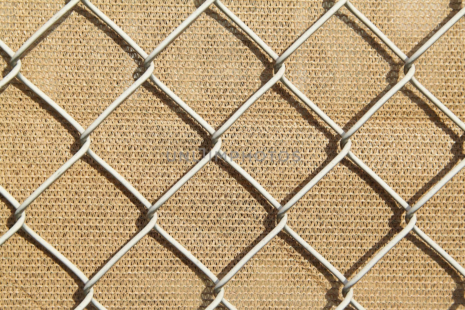 Metal fence with the light brown background