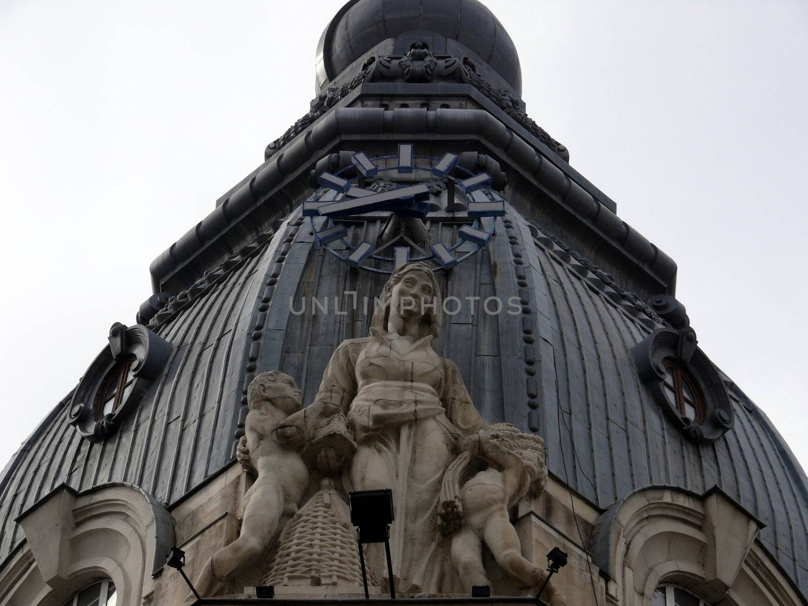 Sculptures with clock in the roof. Sofia, Bulgaria by Stoyanov