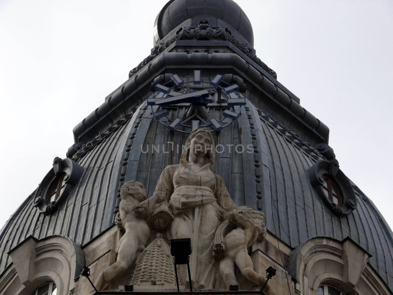 Sculptures with clock in the roof. Sofia, Bulgaria