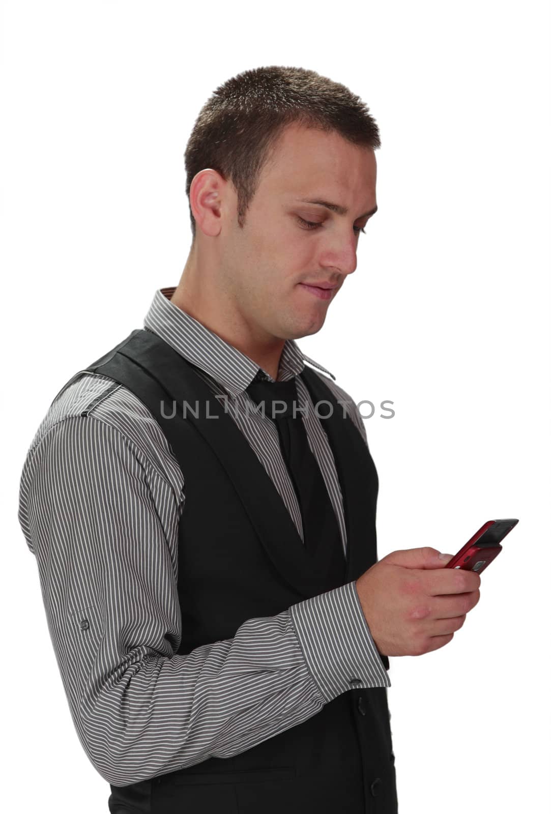 Young busienssman checking his mobile phone isolated against a white background.