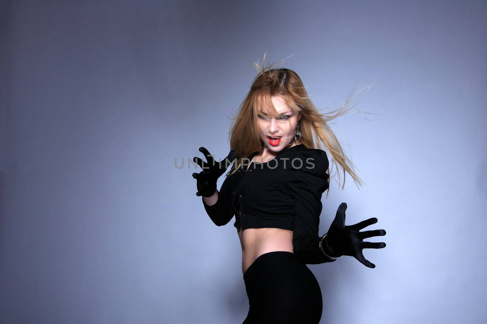 Attractive young fashion model over gray background