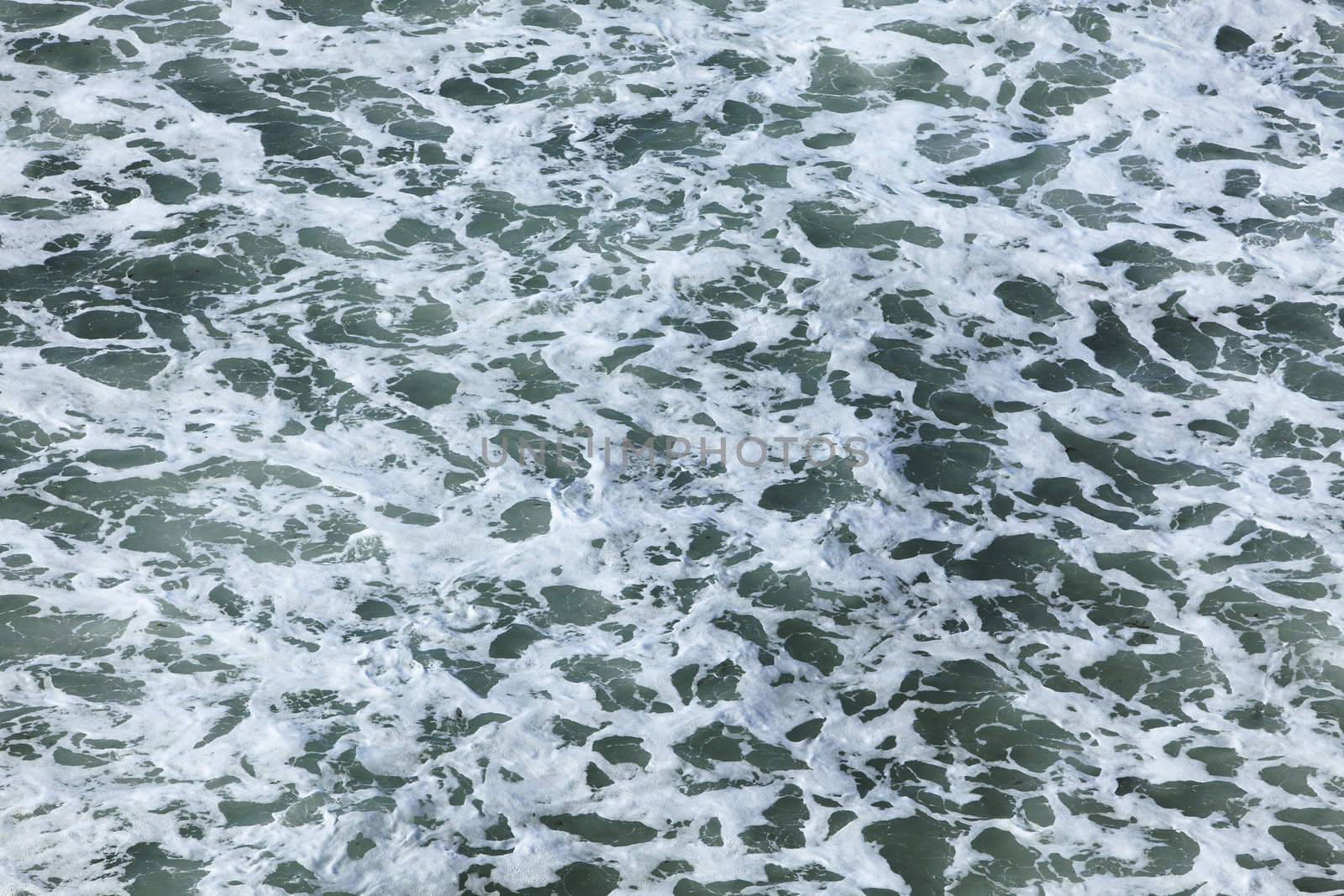 Aerial view of the foamy ocean surface just after a wave.