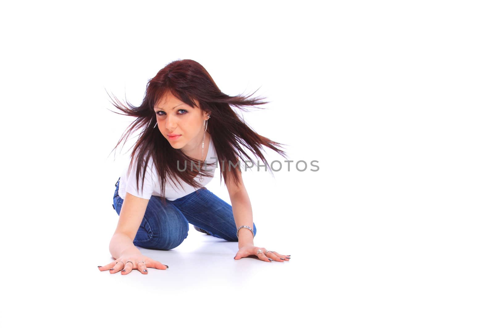 smiling young woman in jeans and t shirt, studioshot over white background