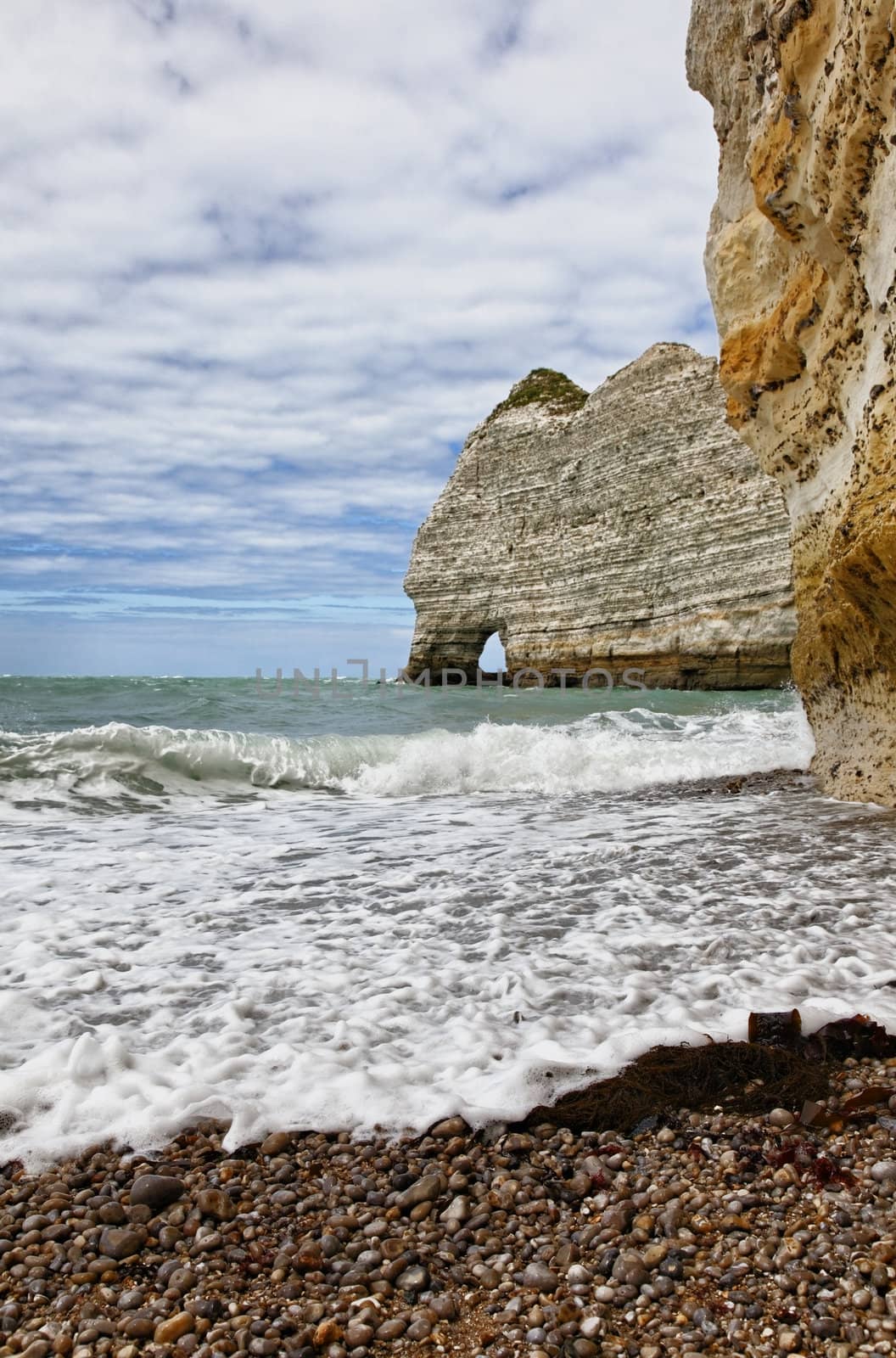 Image of stones and ocean.Location: La Falaise d'Amont in Etretat on the Upper Normandy coast in the North of France.