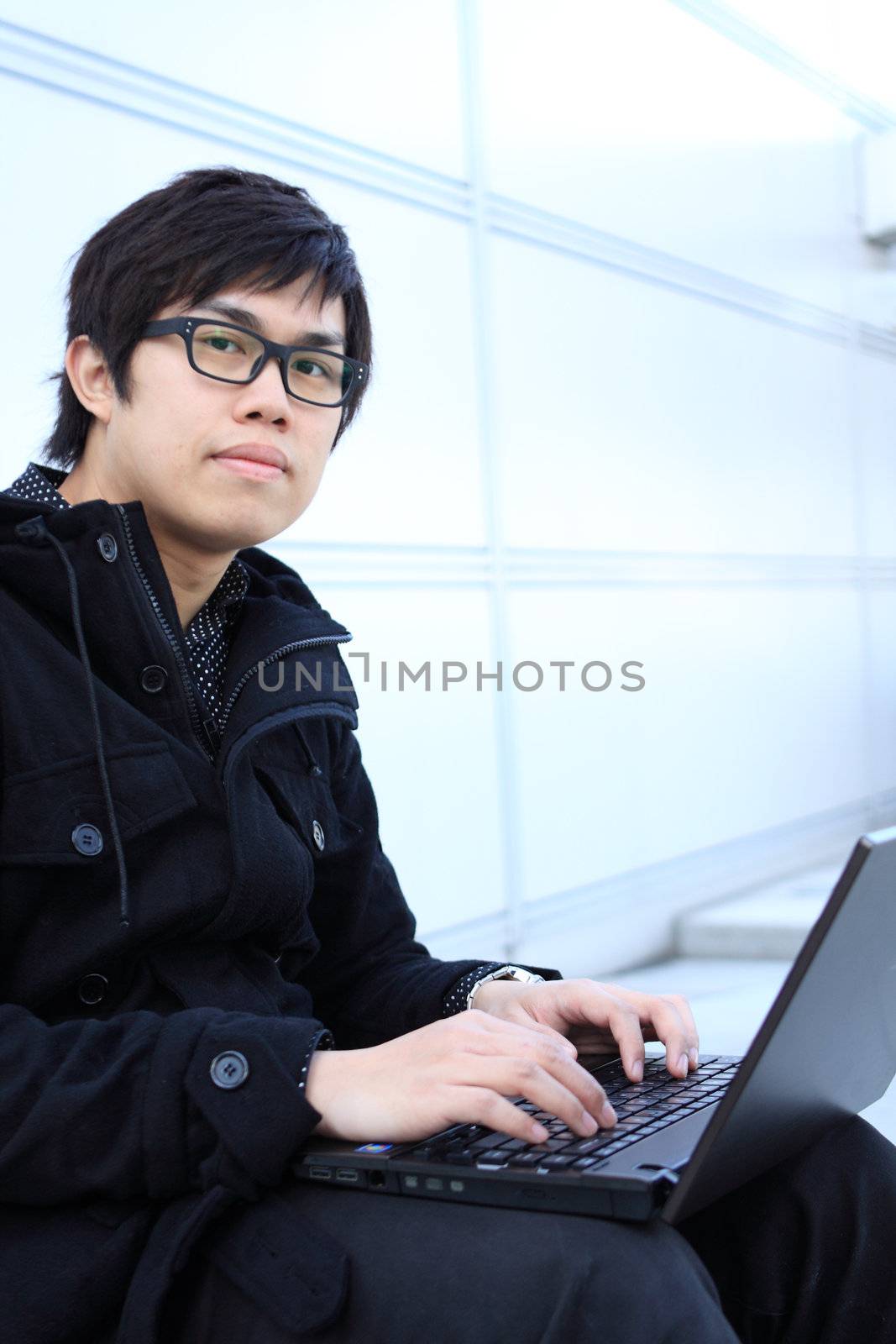 young man works for a laptop at outdoor