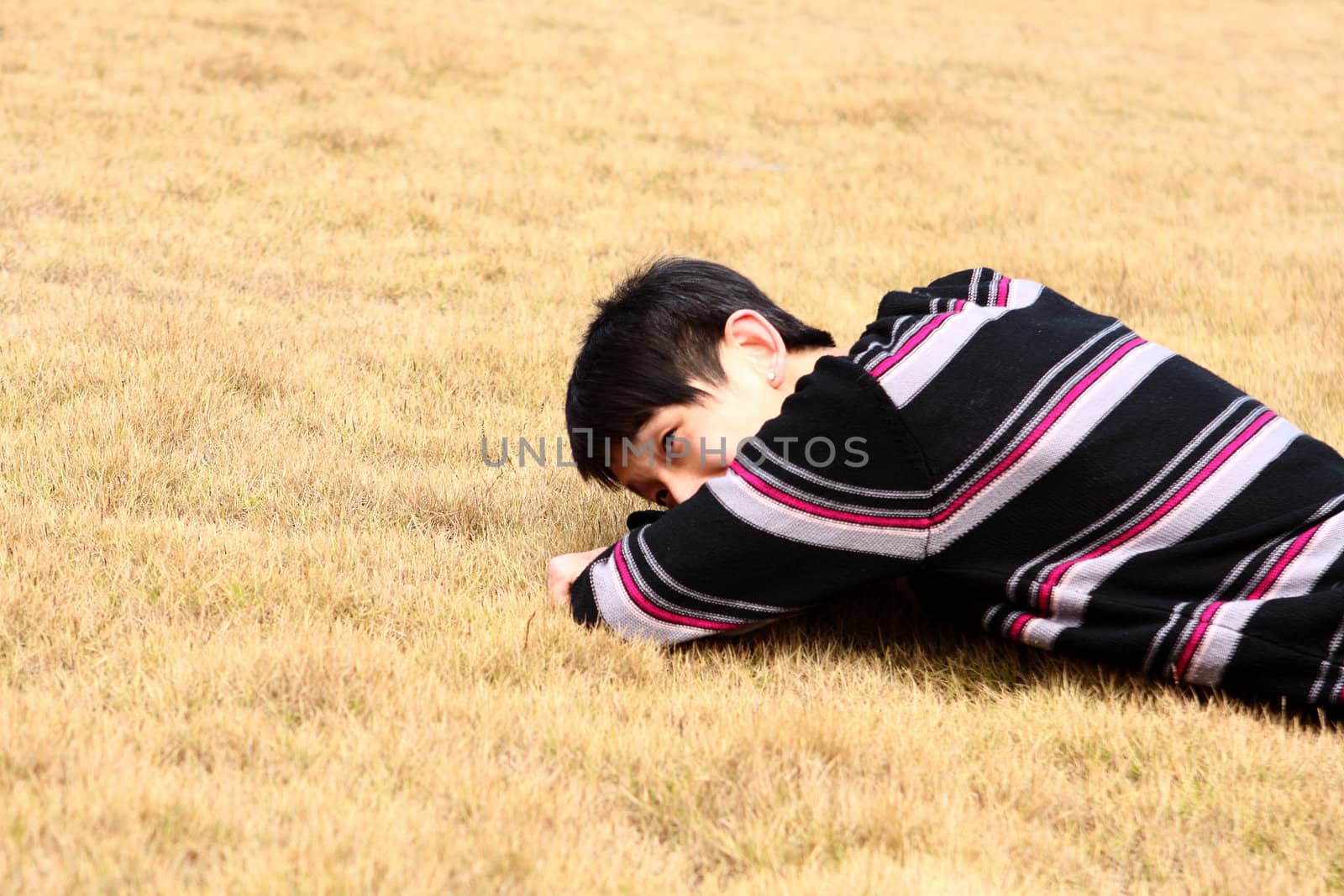 Young man lying on grass  by cozyta