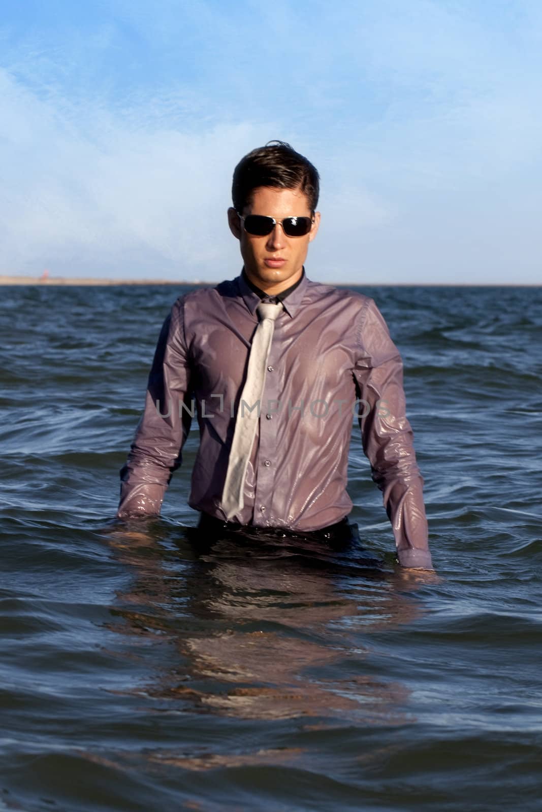 Fully dressed business man on the water .