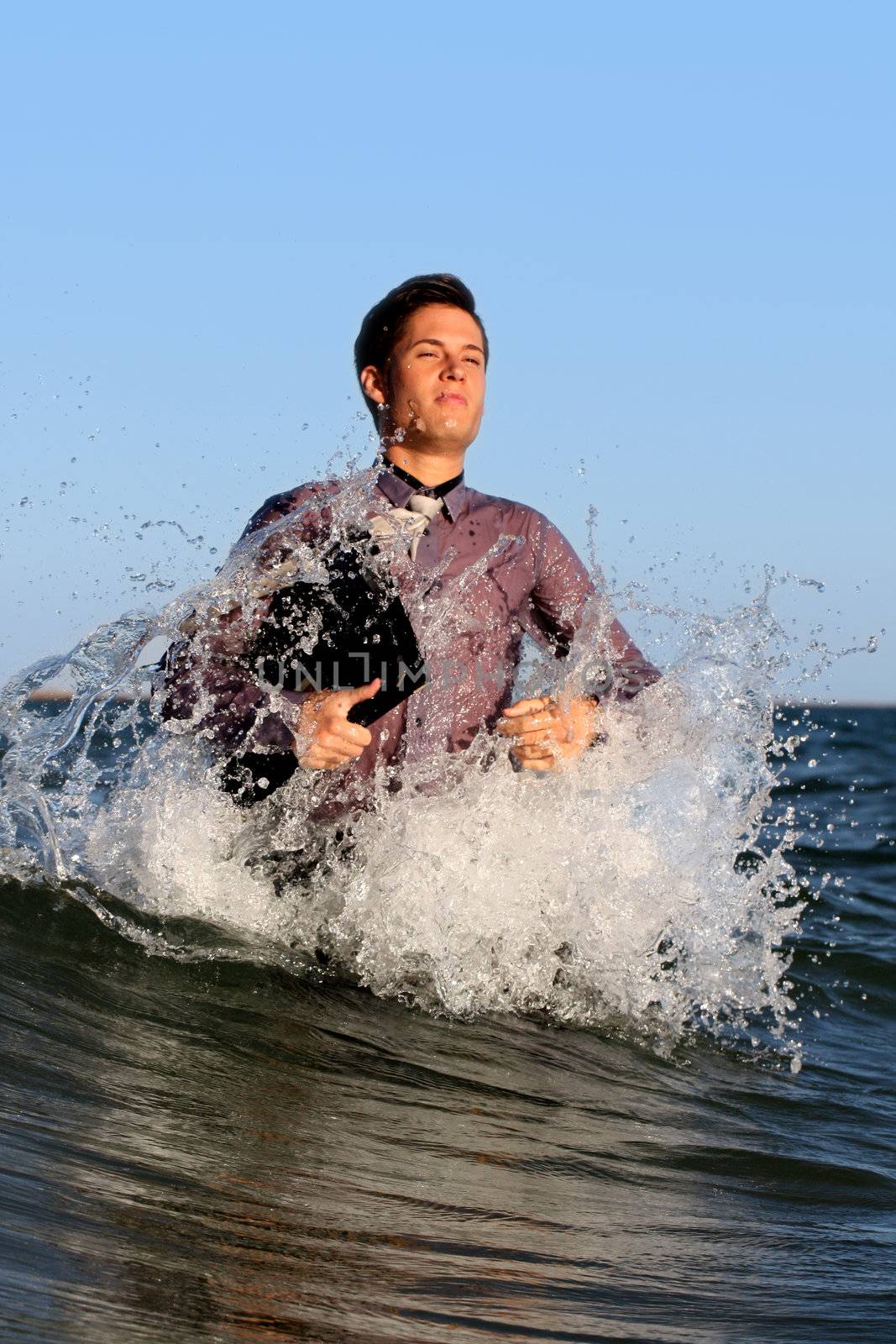 business man burst from the deep sea making splash of water.