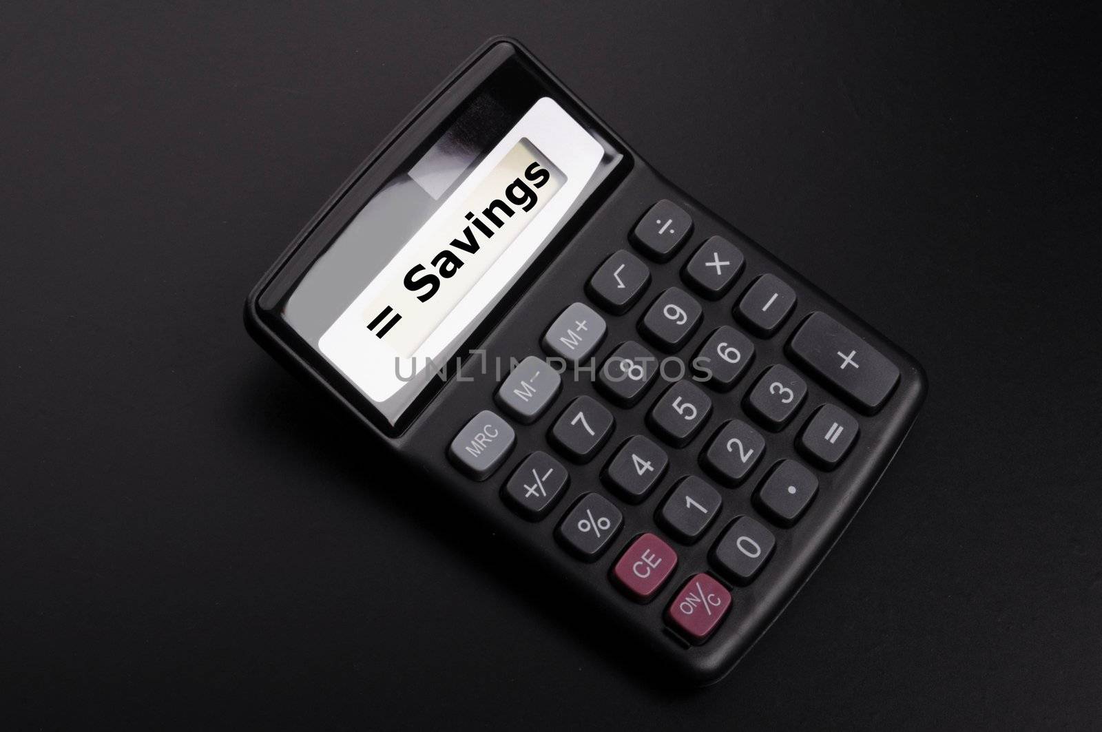 save money concpet with word savings on calculator