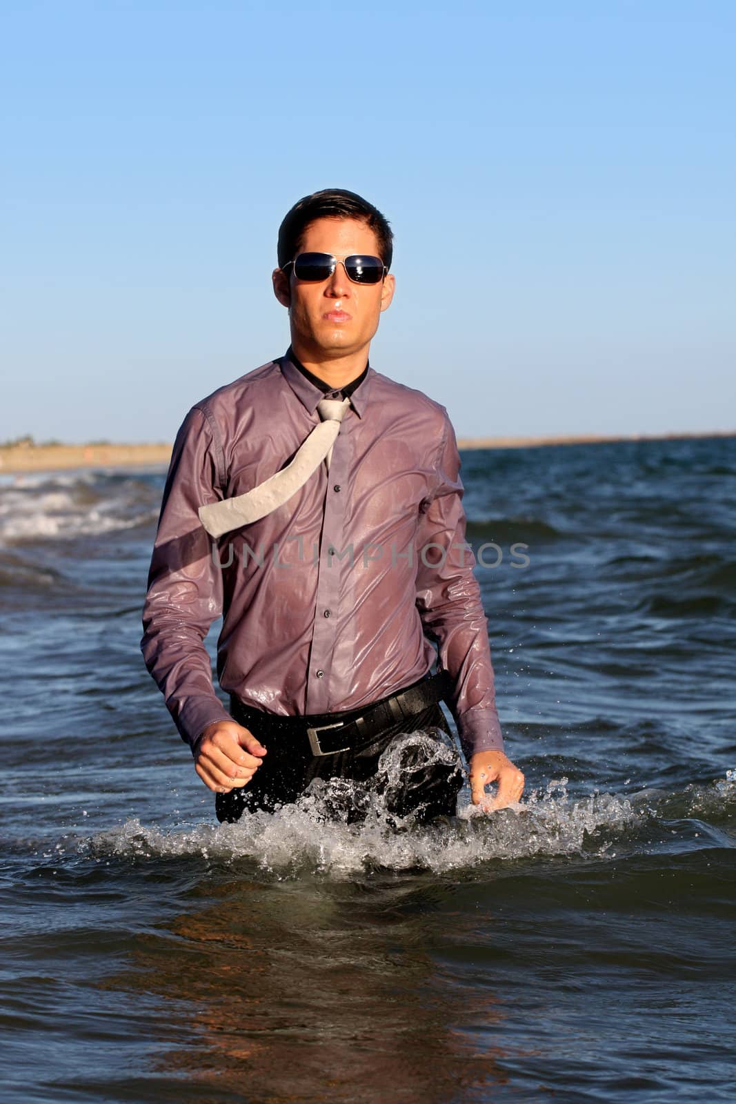 Fully dressed business man on the water .