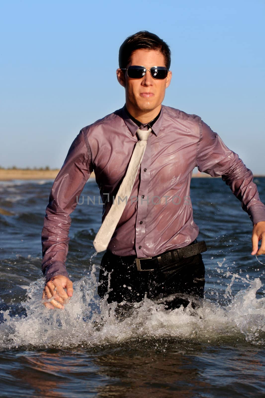 Fully dressed business man on the water .