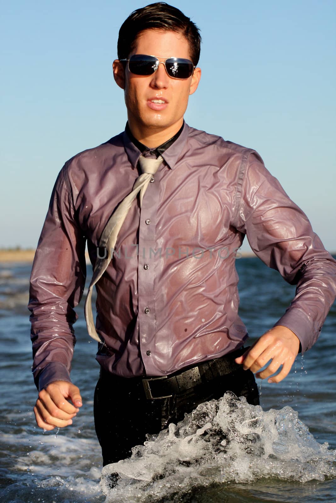 Fully dressed business man on the water .