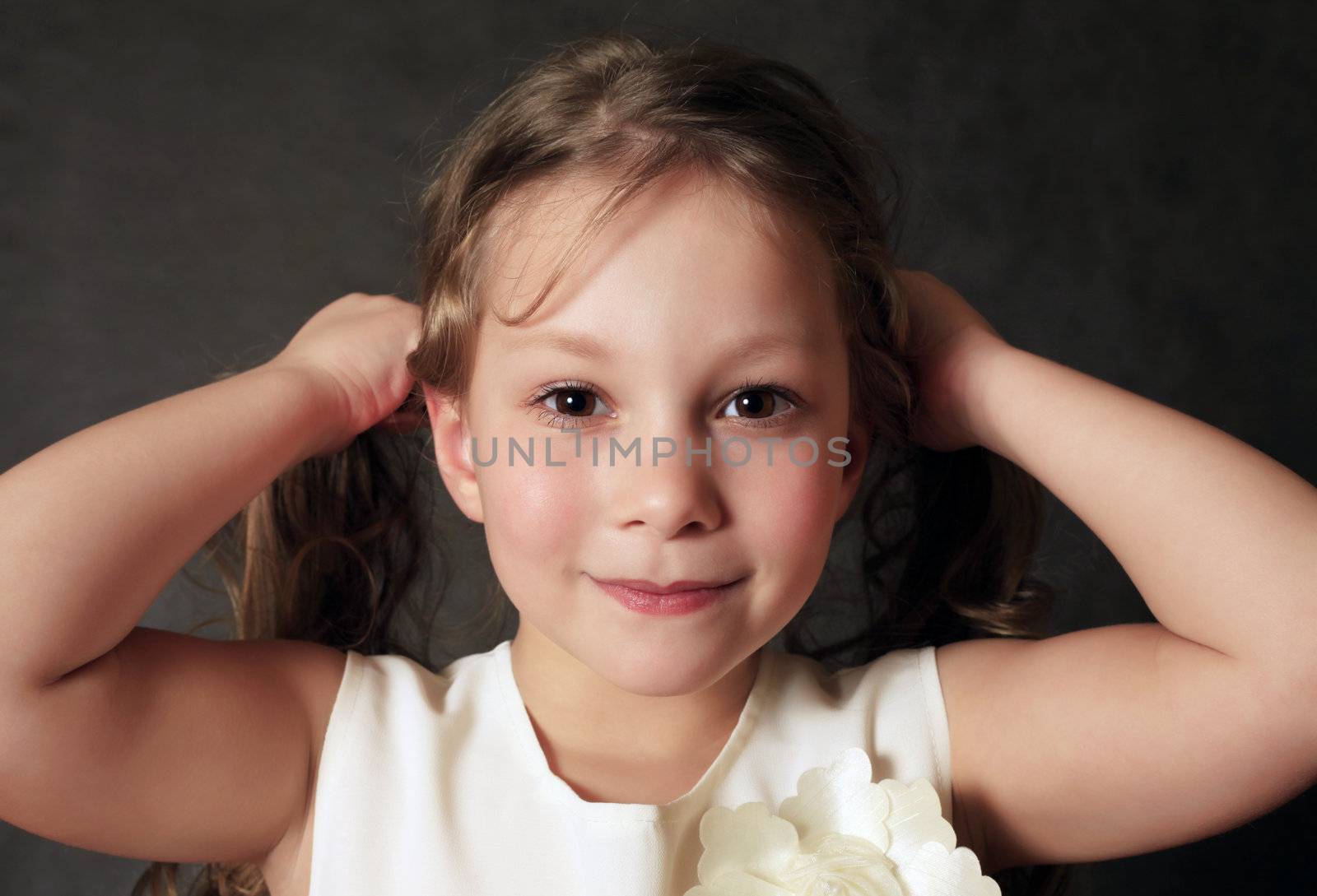 Portrait of young girl smiling on black background