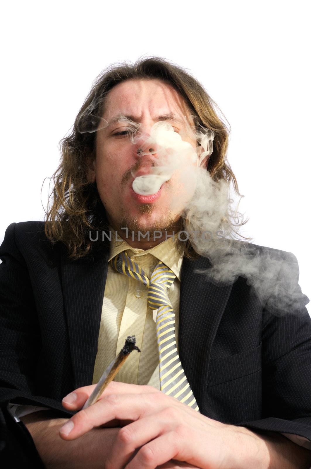 Young business man smoking weed after work