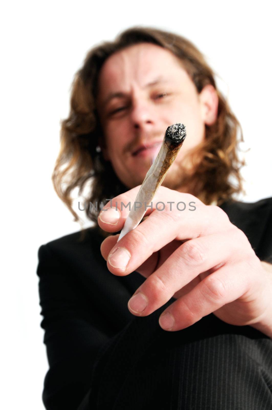 Young business man smoking weed after work