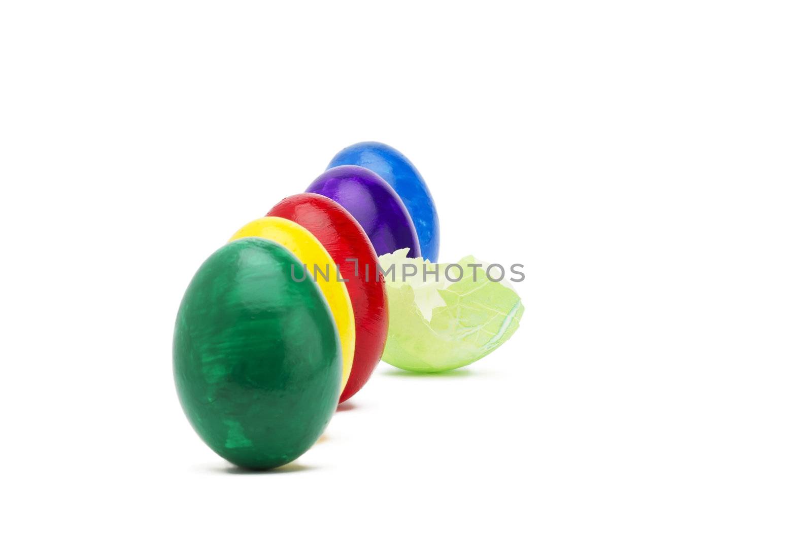 light green broken easter egg between other easter eggs on white background