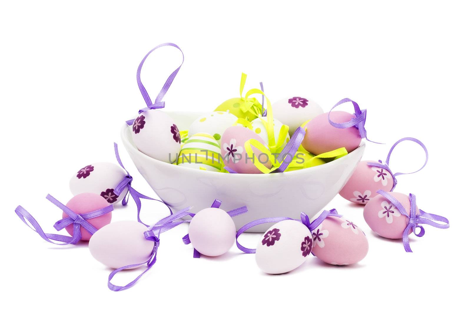 small tender pastel easter eggs in a white bowl on white background
