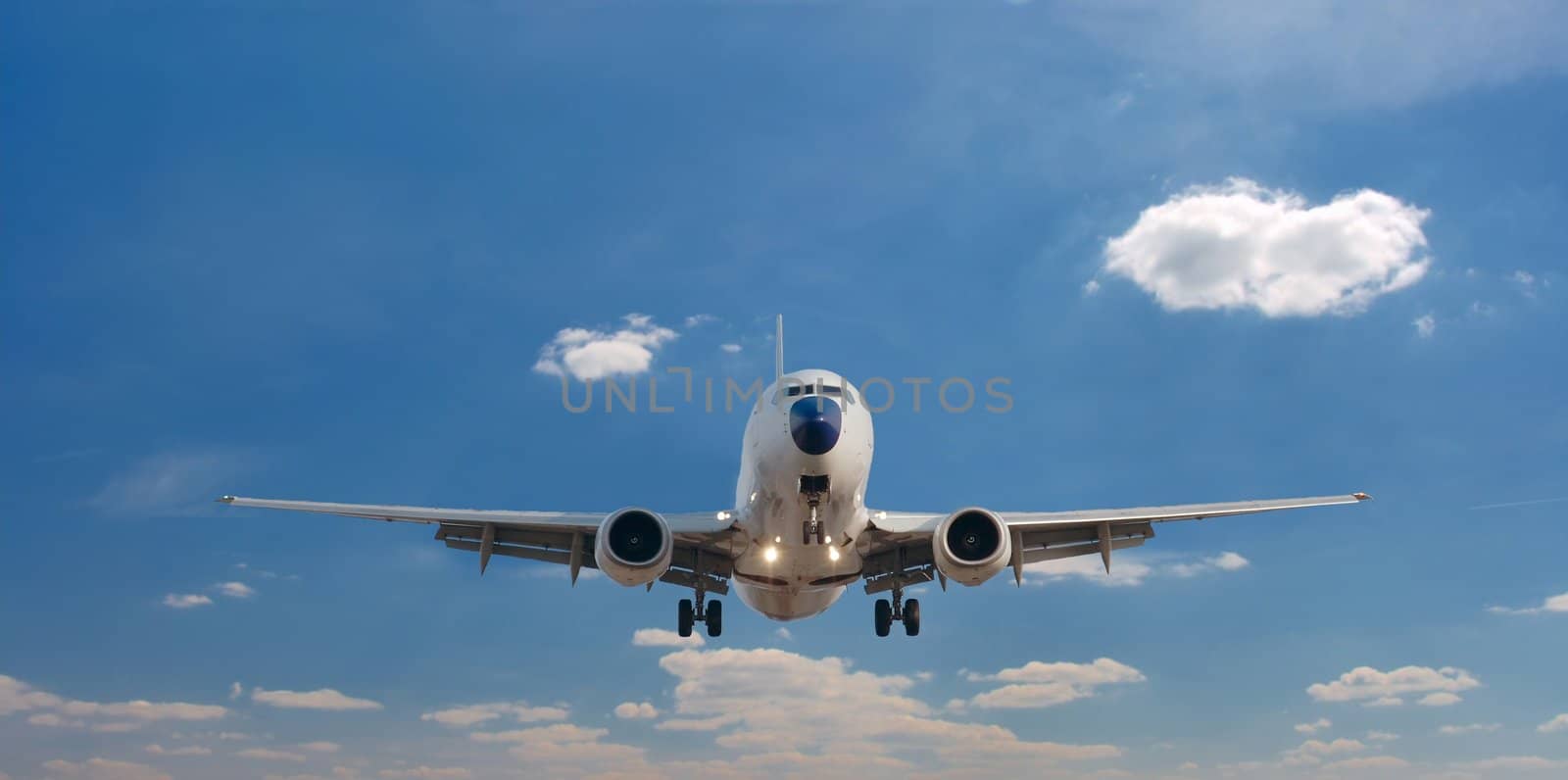 Airplane landing against clear blue sky