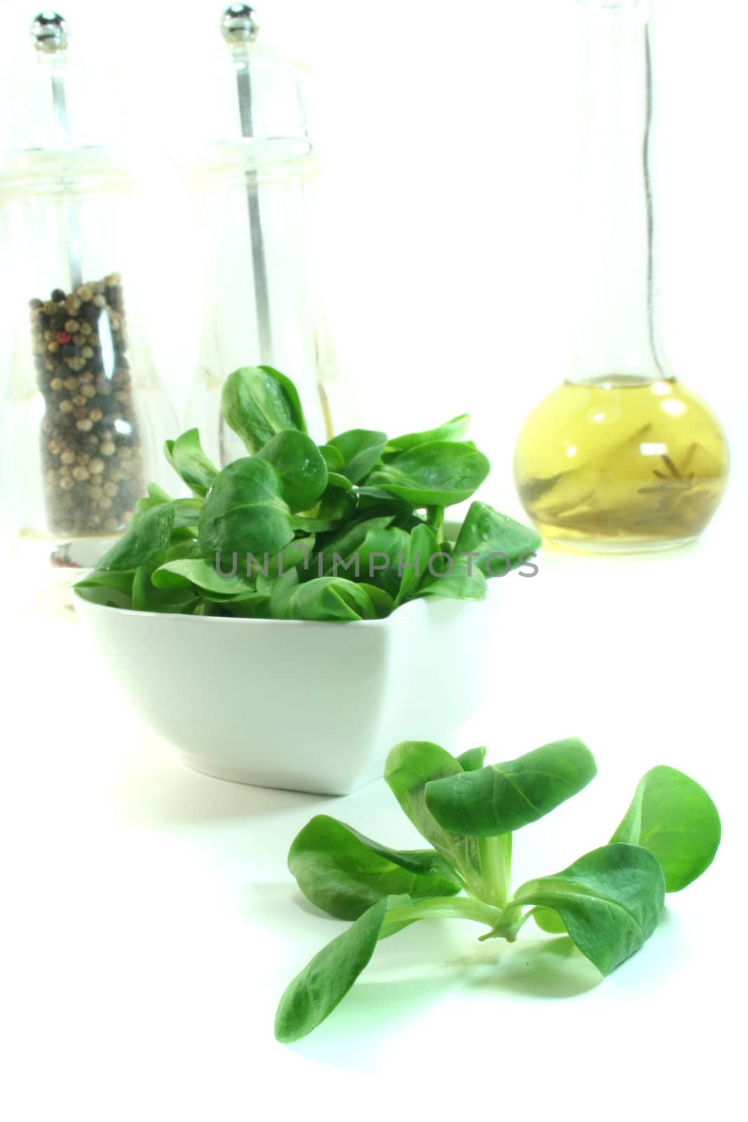 Lamb's lettuce in a bowl on a white background